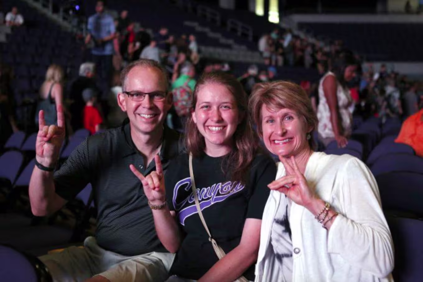 parents and student holding a lopes up