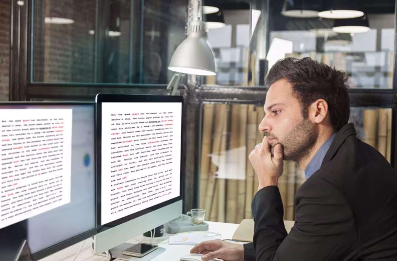 Editor reviewing document at computer