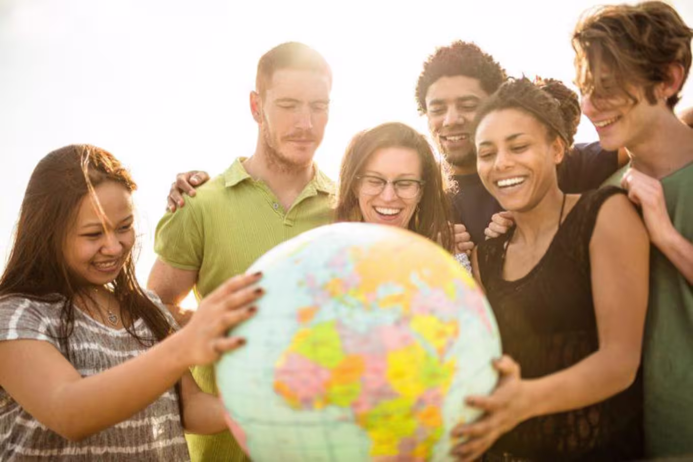 International students gathered around a globe