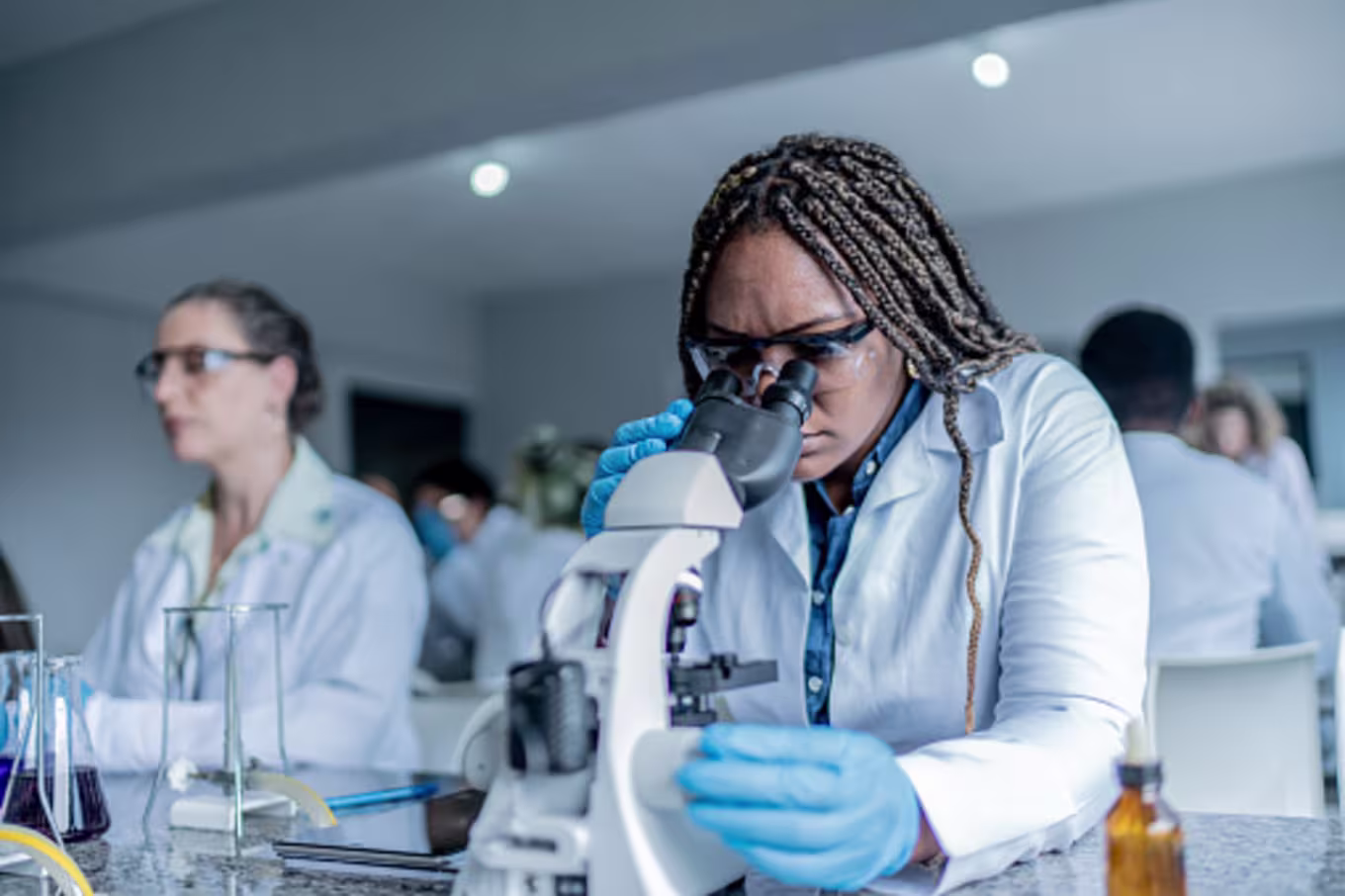girl in class looking in microscope