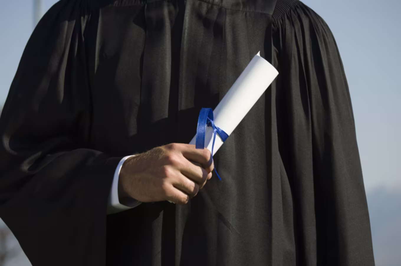 Graduate holding diploma