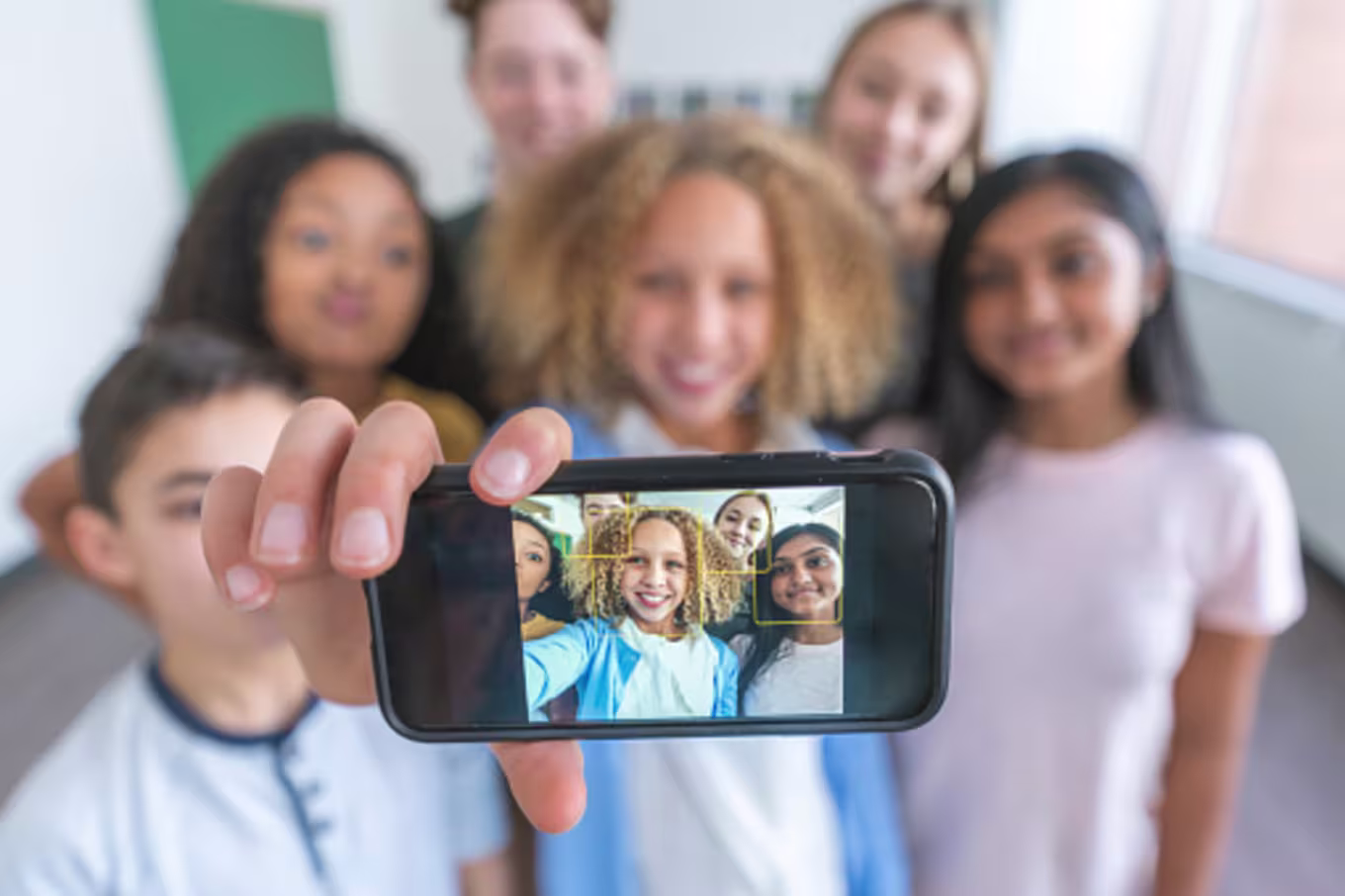 Teacher and students taking selfie for social media in classroom