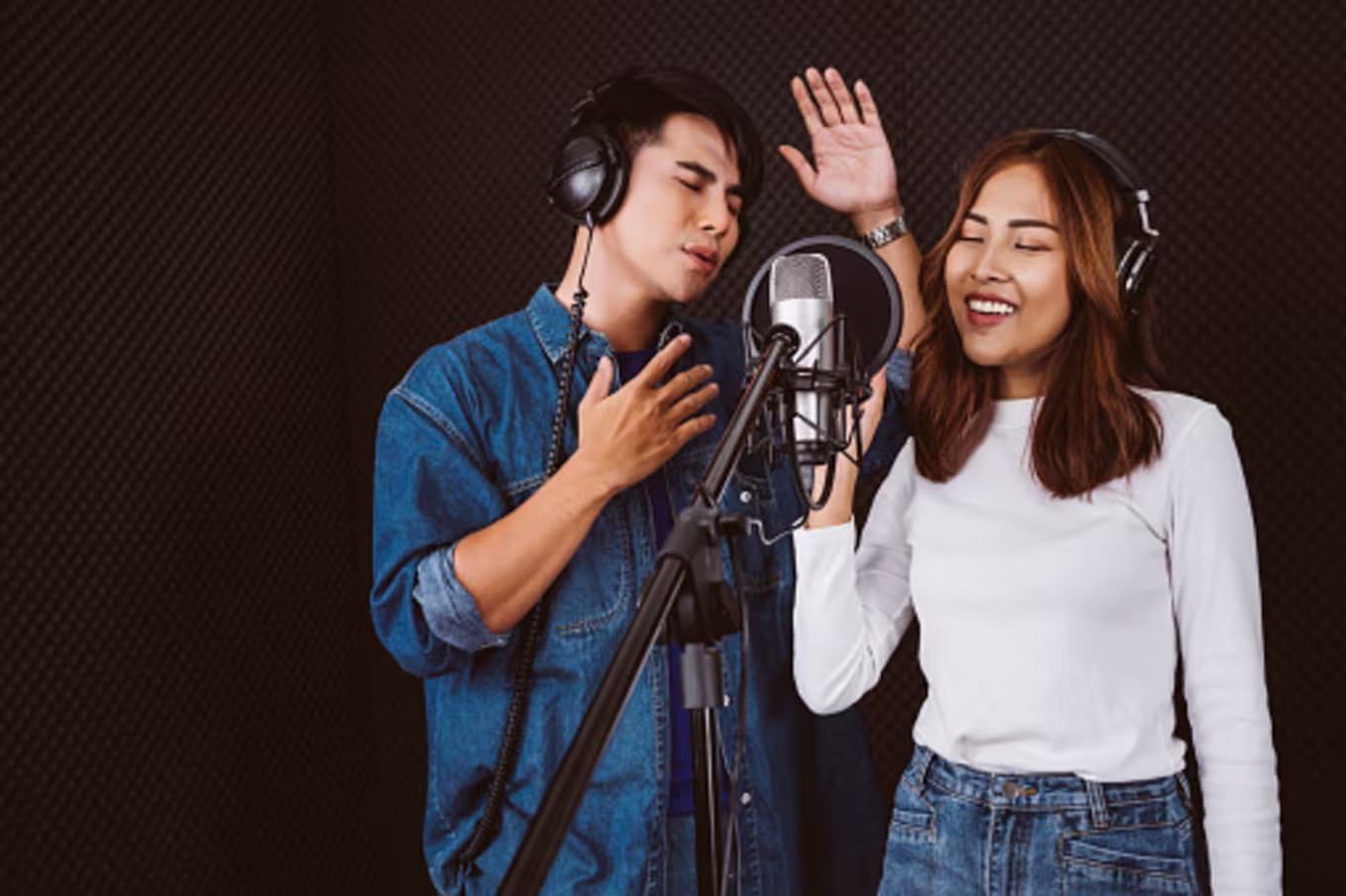 Male and female session musicians singing together in studio