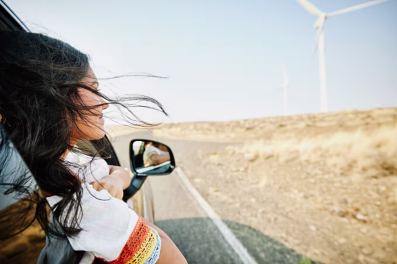 Young woman trusting in God's promises and smiling in car