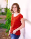 Photo of Sarah Kidd leaning against a wall