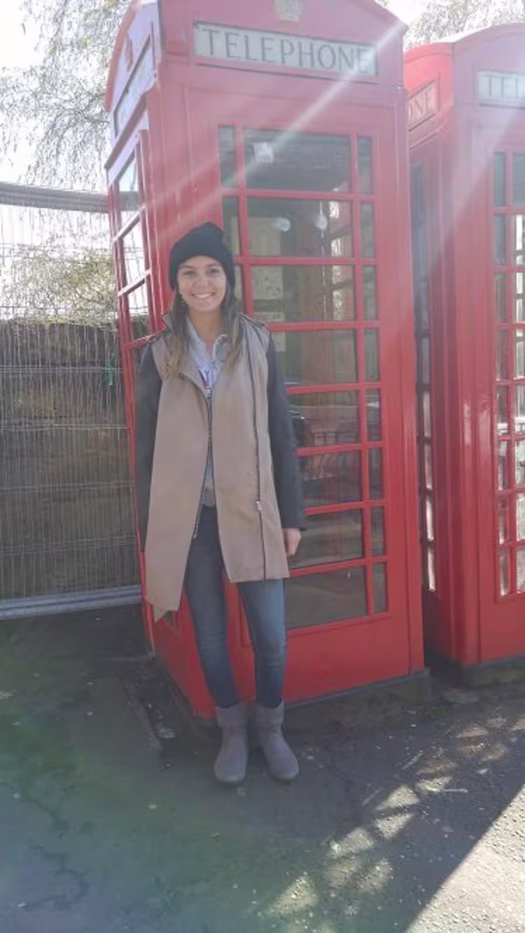 GCU Student Michele standing in front of phone booth in London
