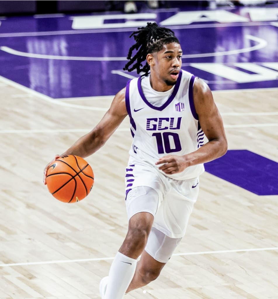 Jaden Henley dribbling during a basketball game.