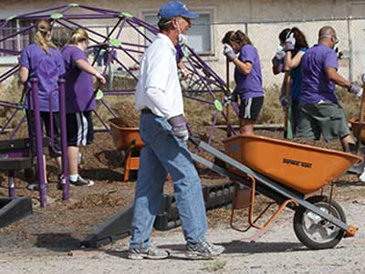 Brian Mueller pushing wheelbarrow