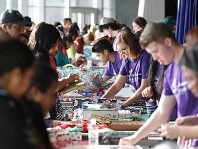 GCU Lopes help wrap toys and gifts from the annual Christmas toy drive.