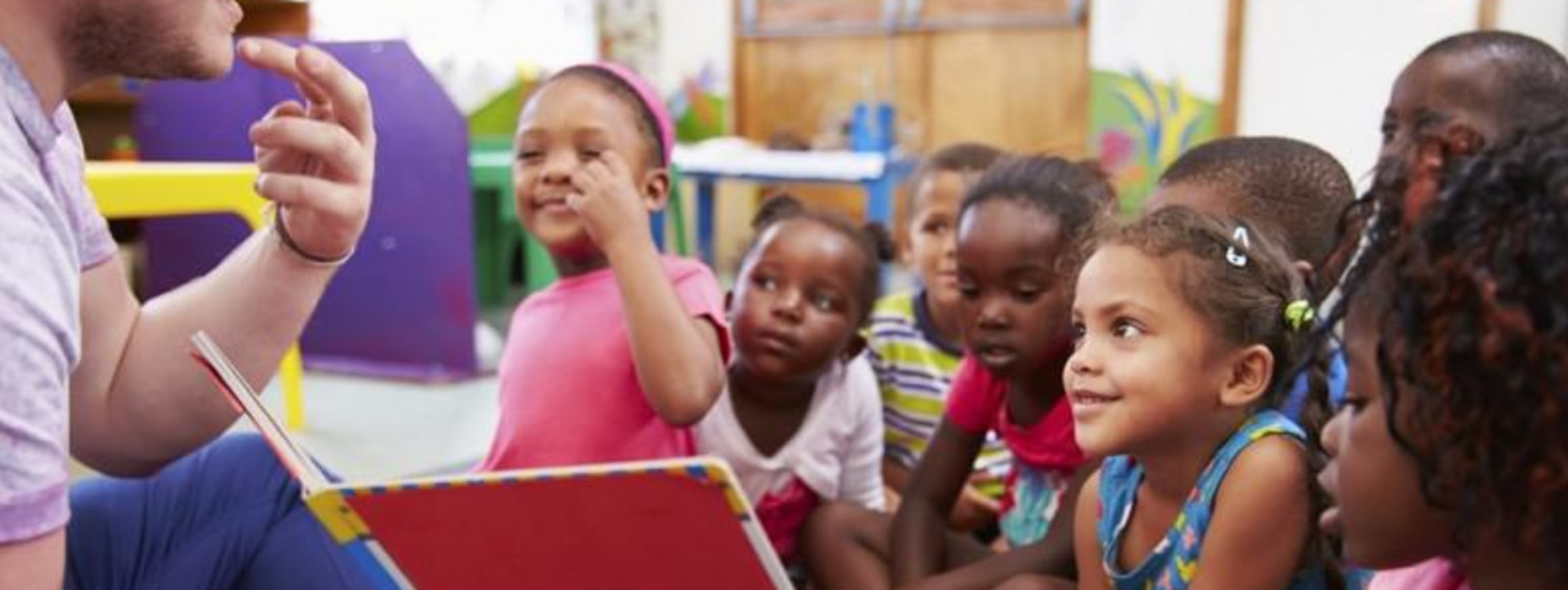 Man reads and signs to kids during storytime