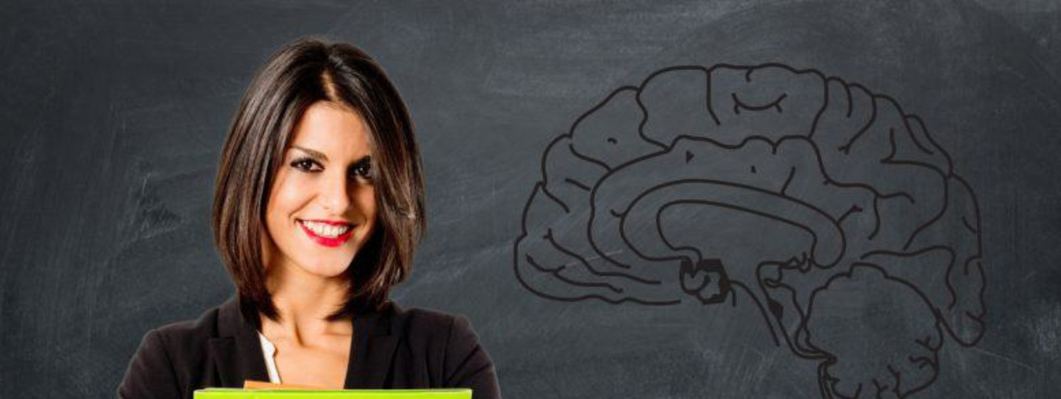 Confident business woman holds bright green folder in front of chalkboard with a brain drawn on it
