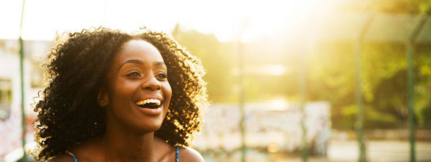 woman smiling and laughing outside
