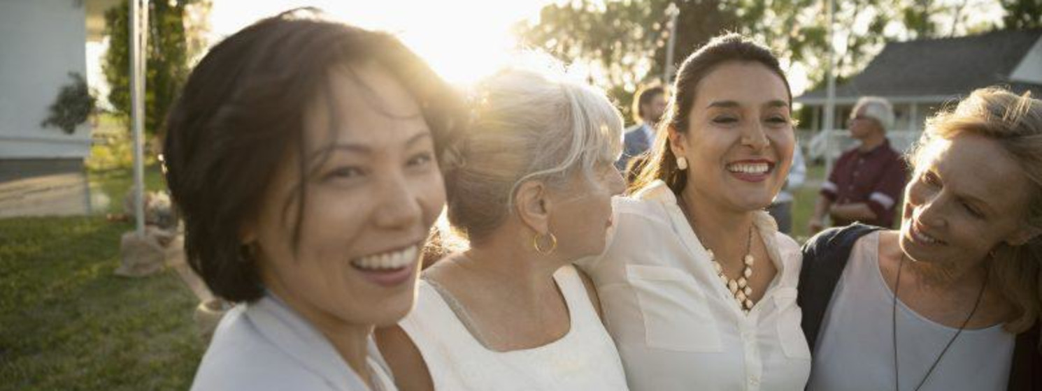 four women laughing together