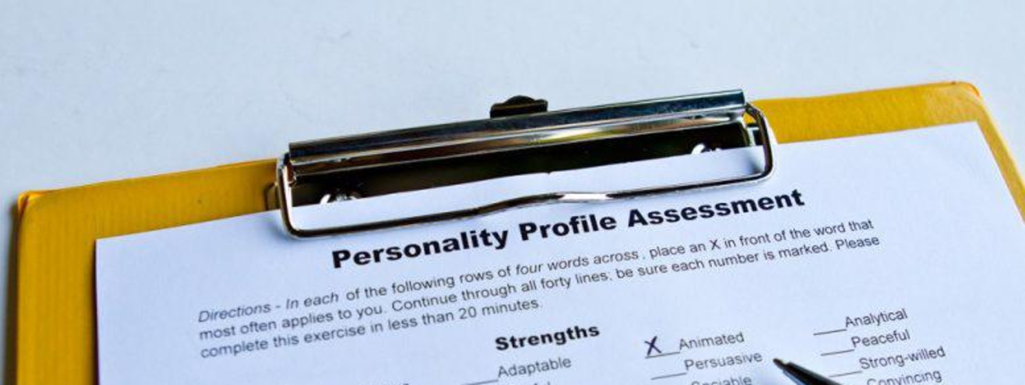 Personality profile assessment on a clipboard with an x next to one characteristic