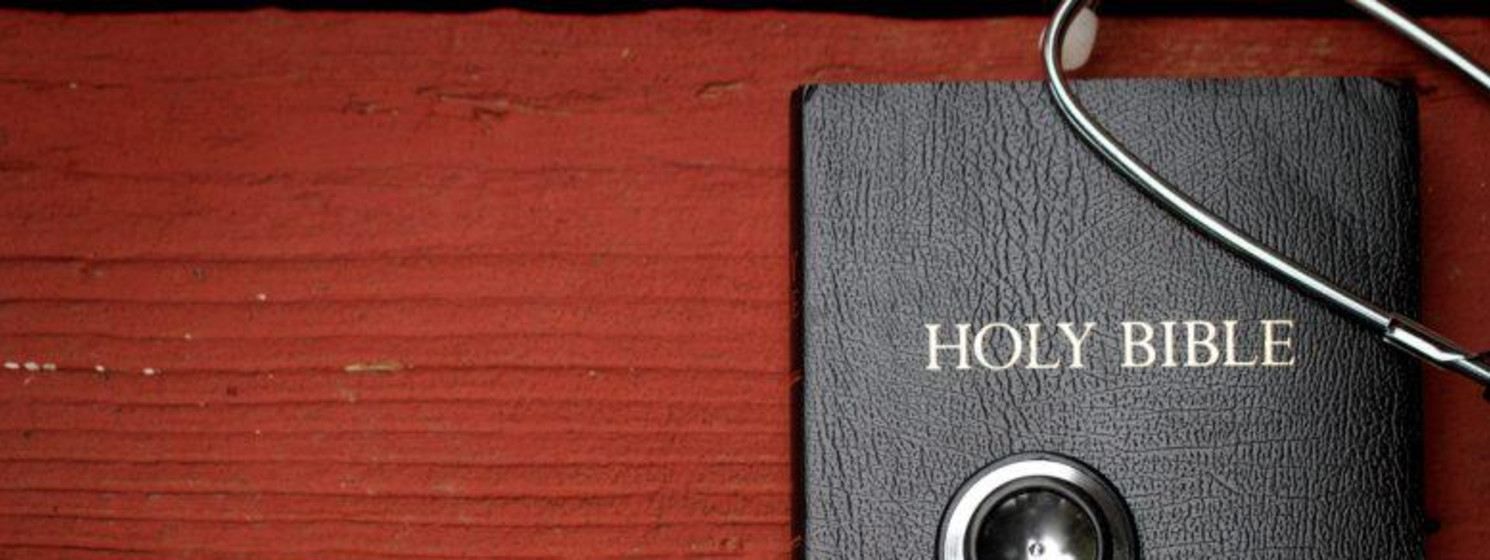 Bible with a stethoscope on top