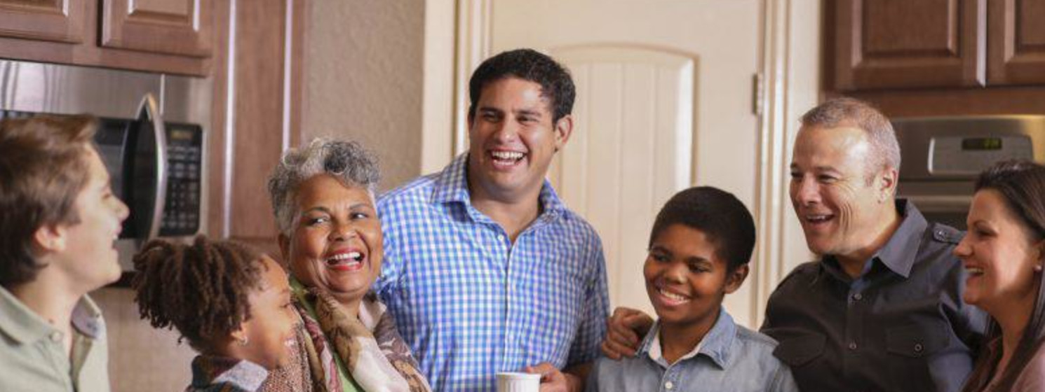 family smiling and laughing in the kitchen