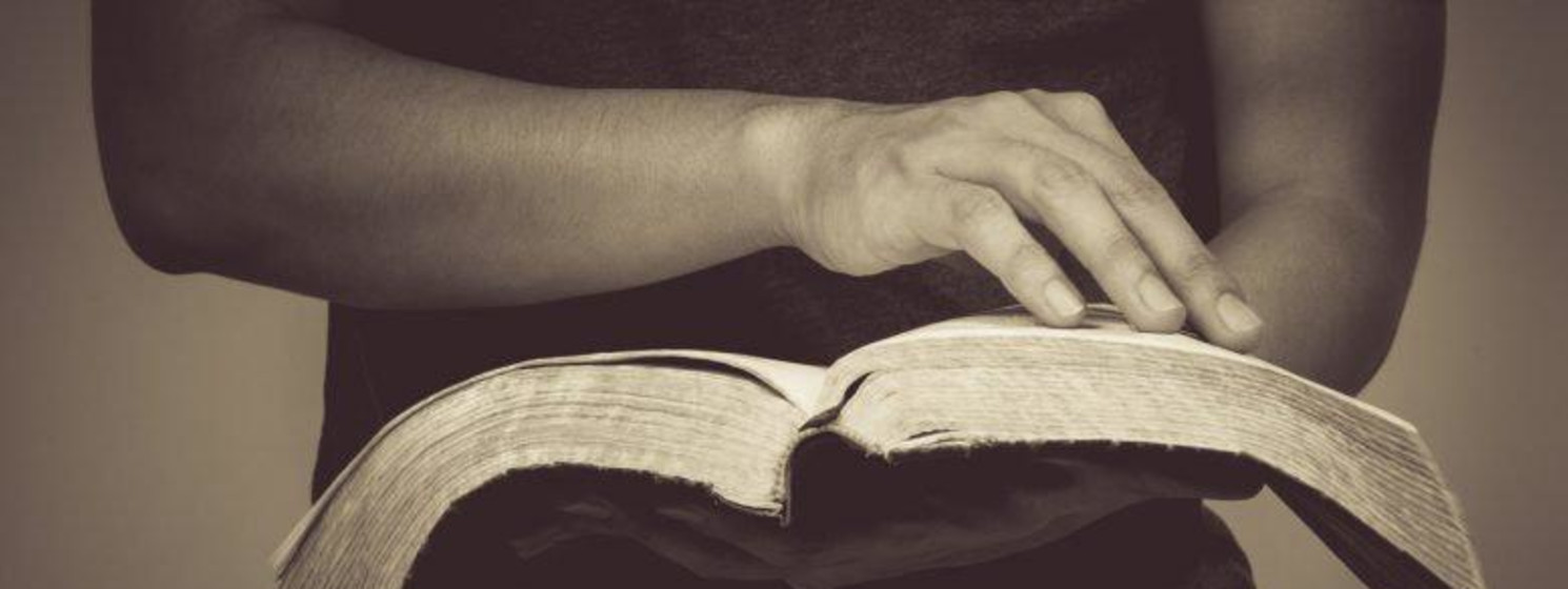 person holding bible