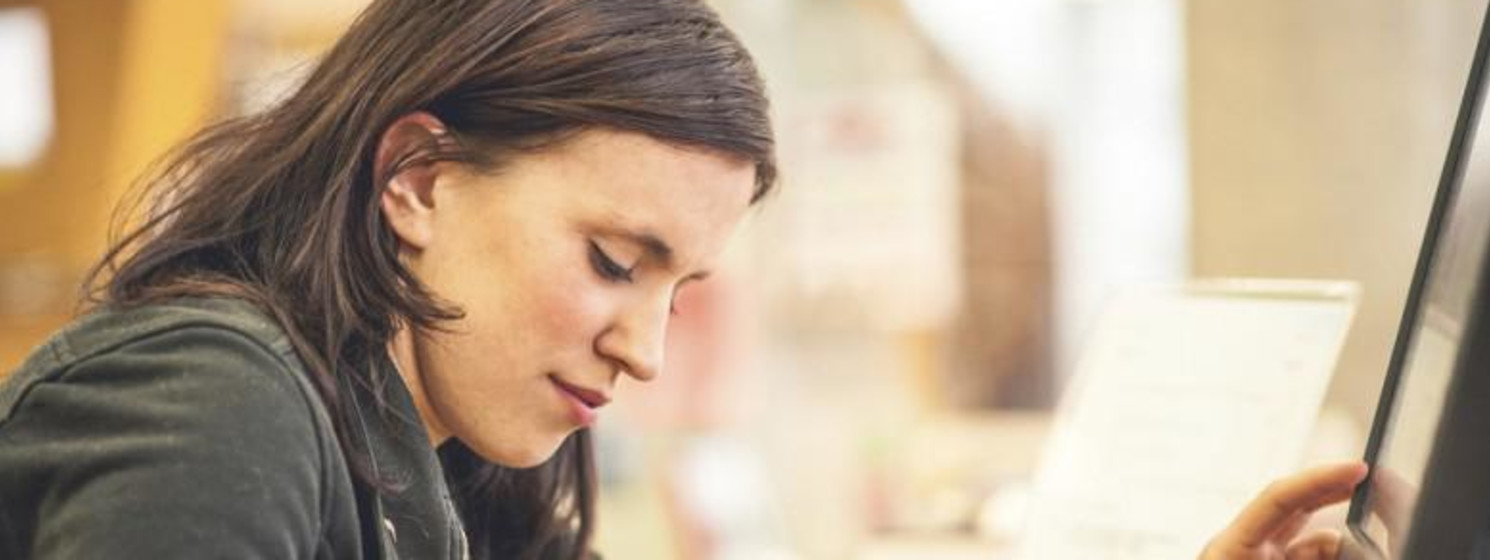Woman looking at laptop while studying