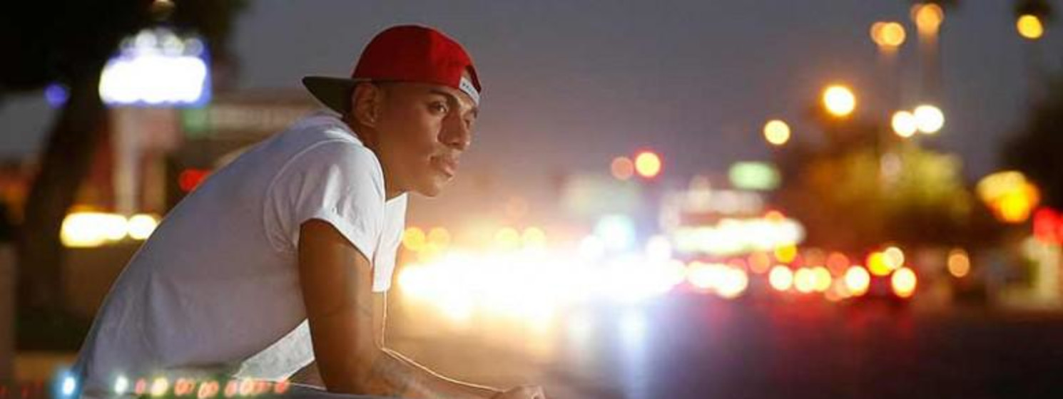 Young person reflecting by a street