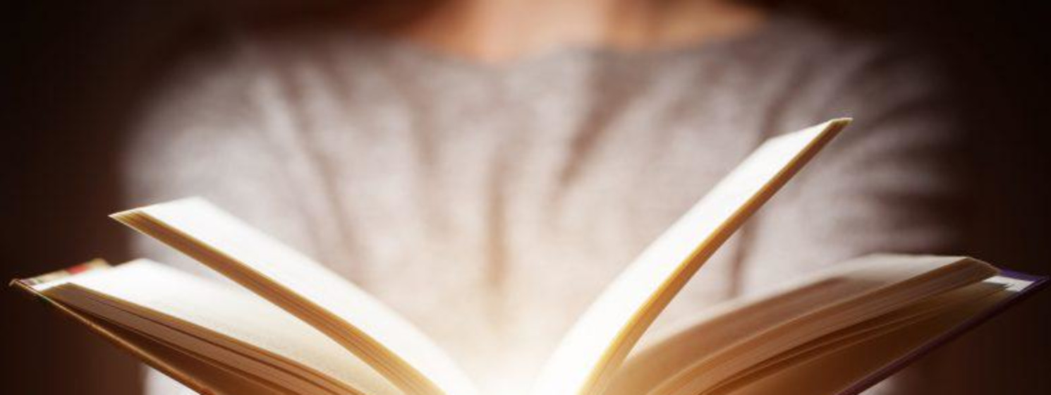 person opening glowing book