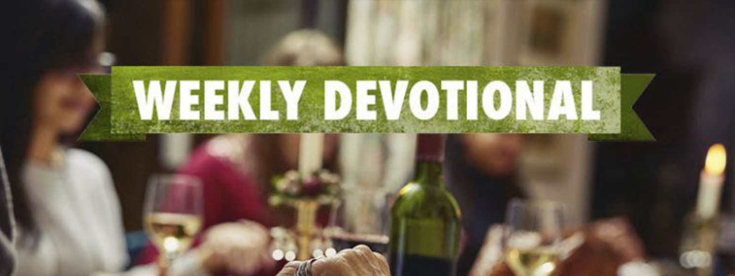 Weekly Devotional: Family praying over a dinner