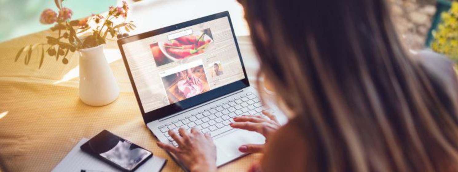 Female food blogger using laptop and working from home