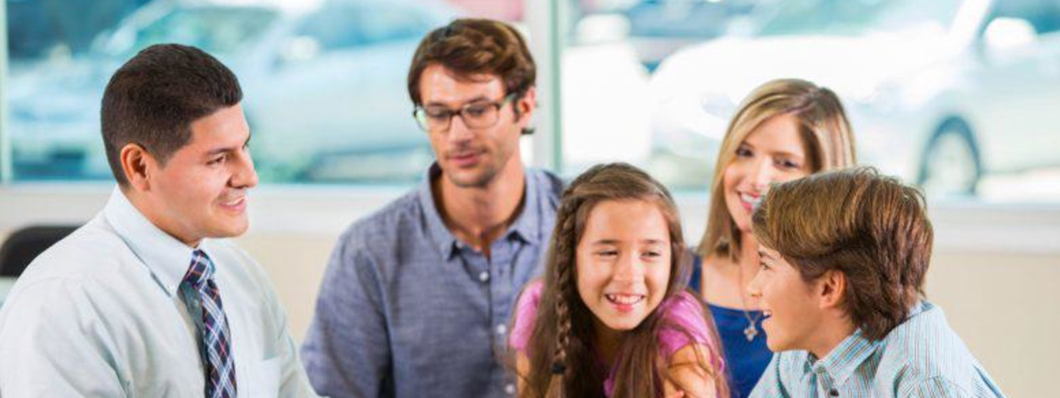 Family counselor asks kids questions with parents behind them