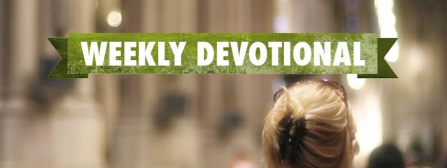 A woman sitting in a pew under the Weekly Devotional banner