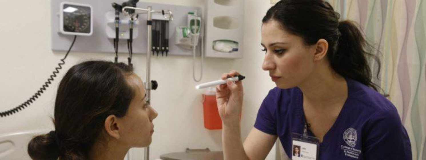 nursing student helping a patient