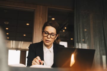 Lawyer sitting at desk with pen and book