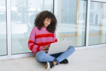 college student working on her online class outside