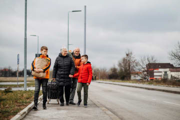 Family serving each other and walking down the road