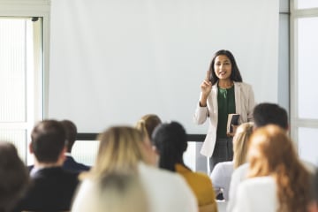 Female teaching a class of entrepreneurs