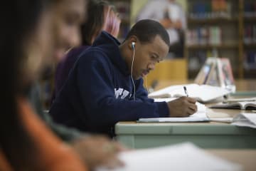 college student studying with music