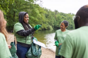 Group of kind people cleaning up nature