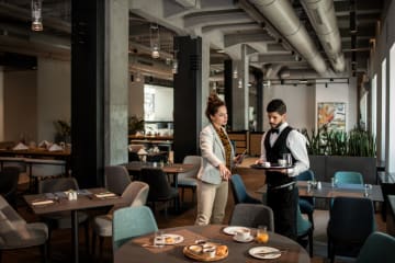 Restaurant manager talking to staff