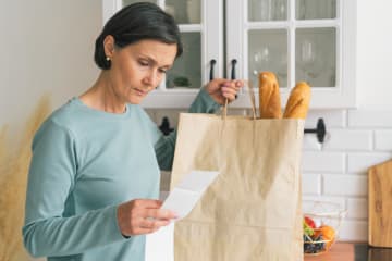woman looking at grocery list