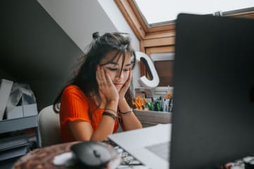 Student looking frustrated at desk