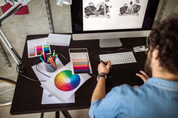 digital artist working with color palette on computer