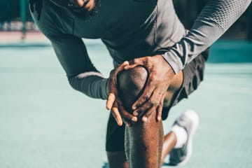 Man checking his knee for pain
