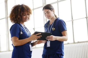 two female nurses meeting and working together