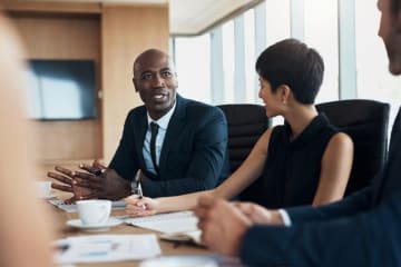 A CEO speaking and managing a office meeting