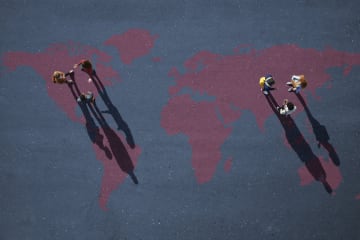 Two small groups of people, having discussion. Standing on world map, painted on asphalt - stock photo