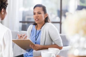 Health psychologist meeting and talking with a patient