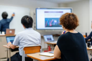 Mid adult woman in a continuing education class at a community college or university - stock photo