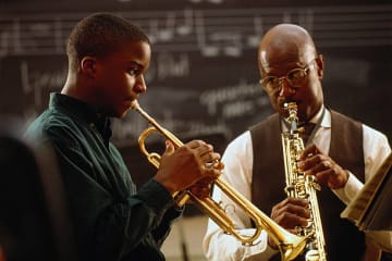 Student and Teacher making music together.