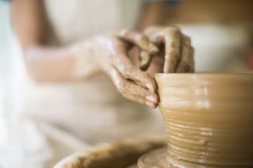 Close up of female potters hands making bowl - stock photo