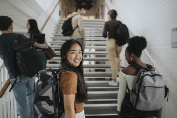Woman with backpack ready to learn business values