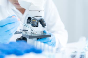 Scientist using a microscope for medical research