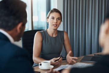 Woman speaks with her coworkers.